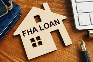 FHA loan written on house cutout.